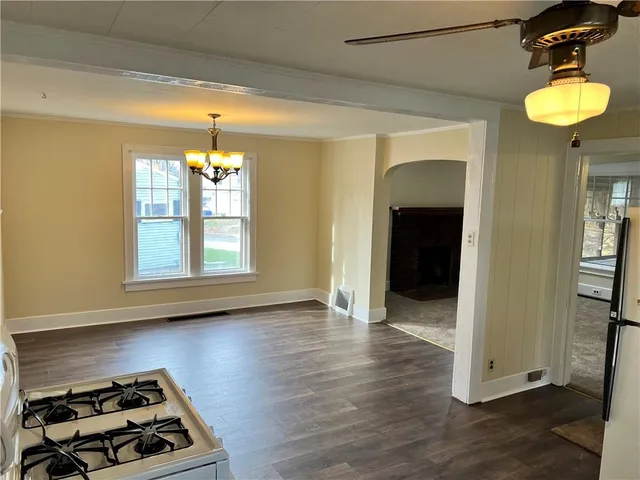a kitchen with wooden floor and a sink