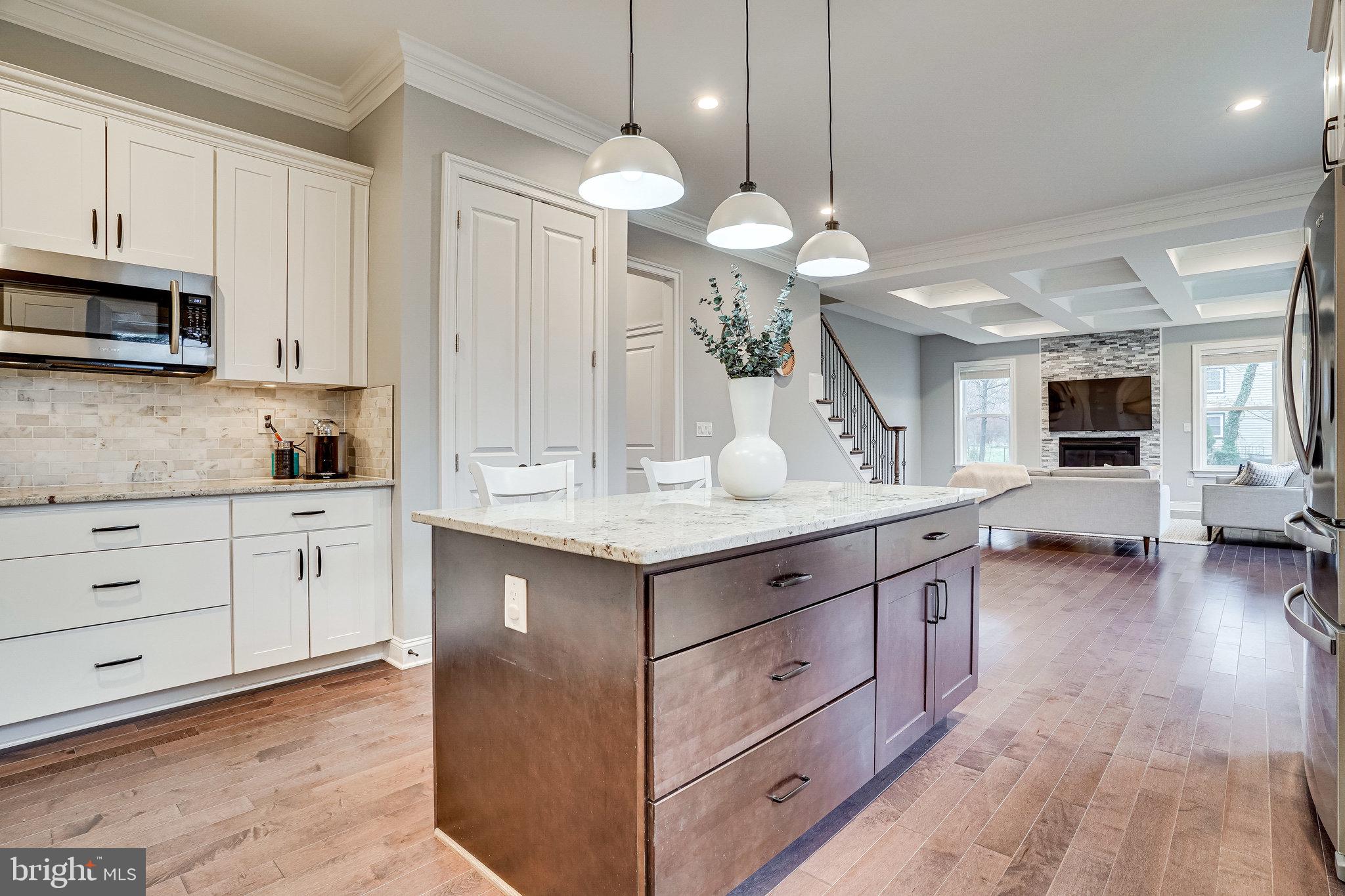 8733 Pohick Road Springfield, VA 22153 - Photo 11 of 40 a kitchen with granite countertop a stove oven and cabinets
