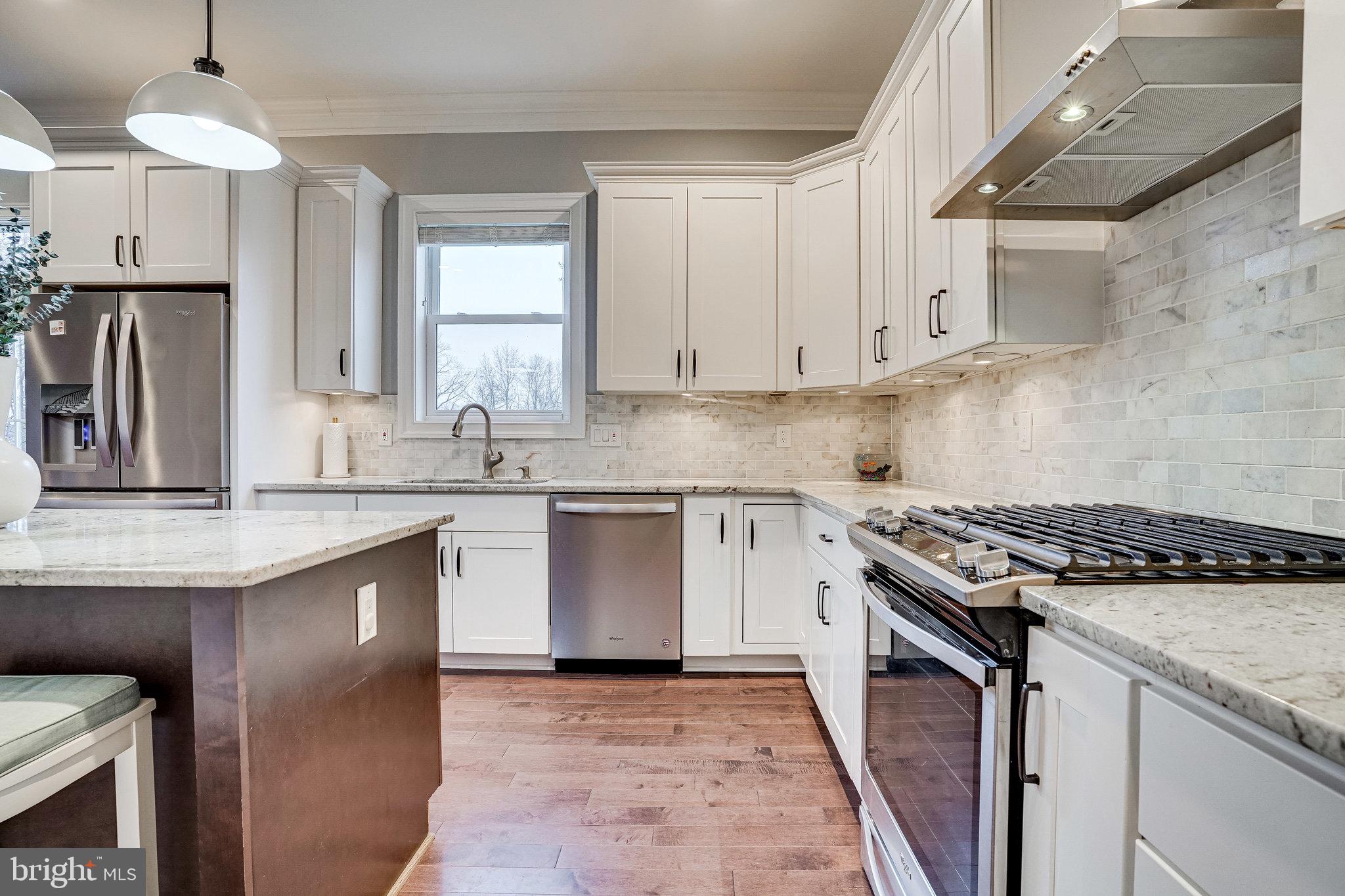8733 Pohick Road Springfield, VA 22153 - Photo 13 of 40 a kitchen with granite countertop a sink stove and refrigerator