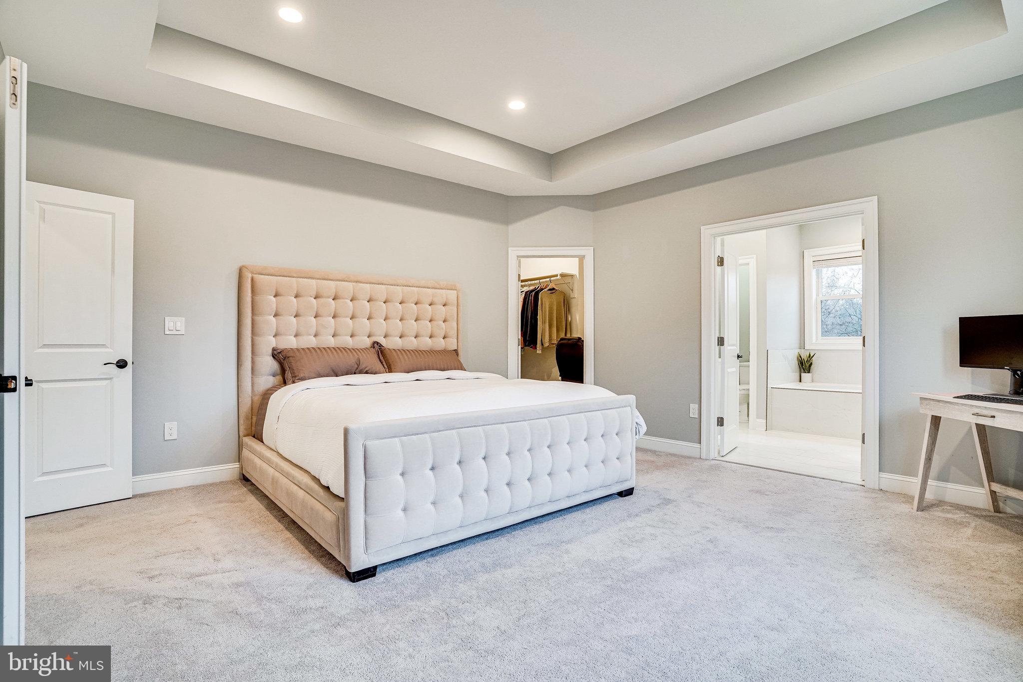 8733 Pohick Road Springfield, VA 22153 - Photo 20 of 40 a spacious bedroom with a bed and a flat screen tv