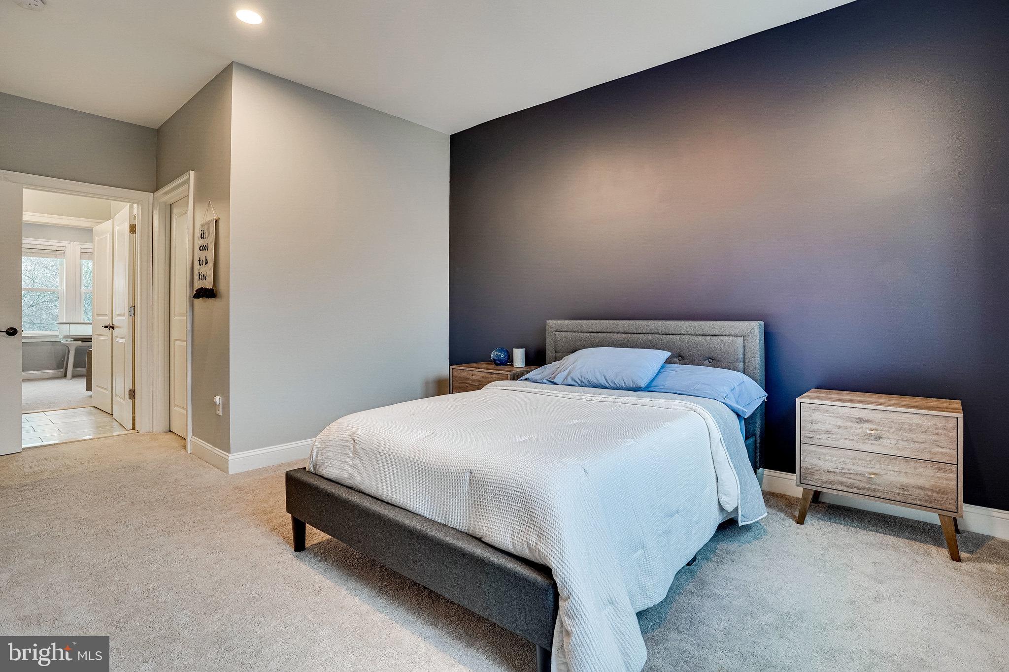 8733 Pohick Road Springfield, VA 22153 - Photo 27 of 40 a bedroom with a bed and a night stand