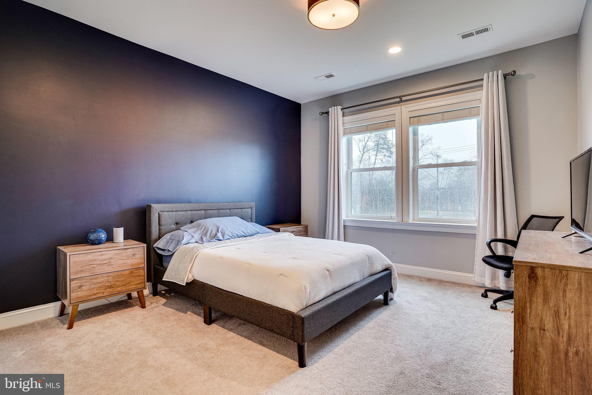8733 Pohick Road Springfield, VA 22153 - Photo 28 of 40 a bed sitting in a spacious bedroom next to a window