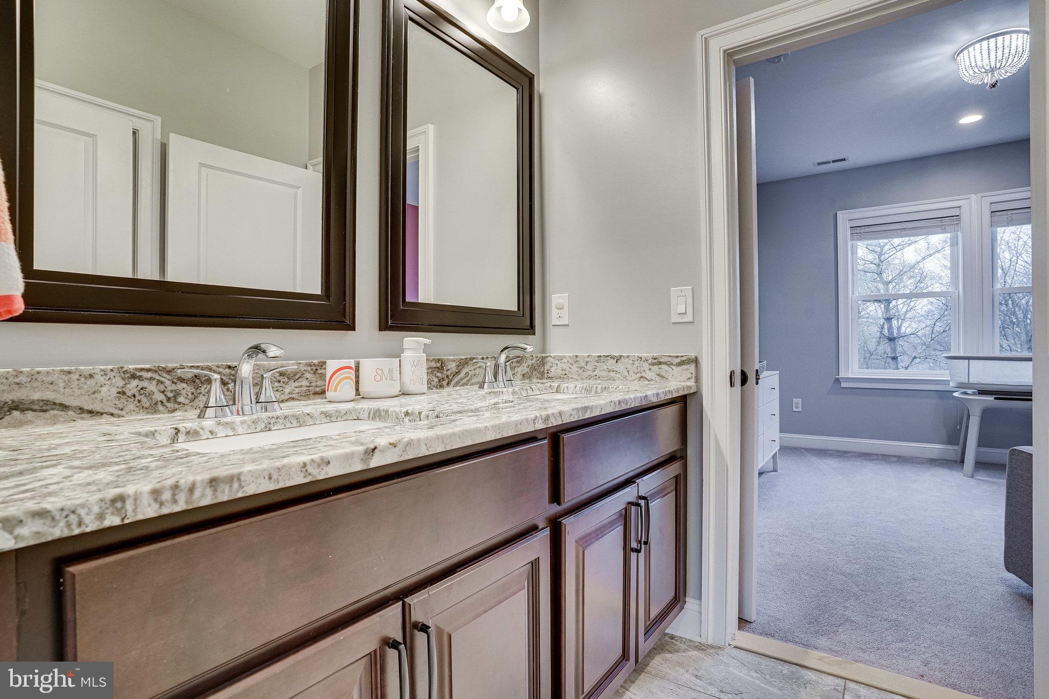 8733 Pohick Road Springfield, VA 22153 - Photo 29 of 40 a bathroom with a sink a vanity and a mirror