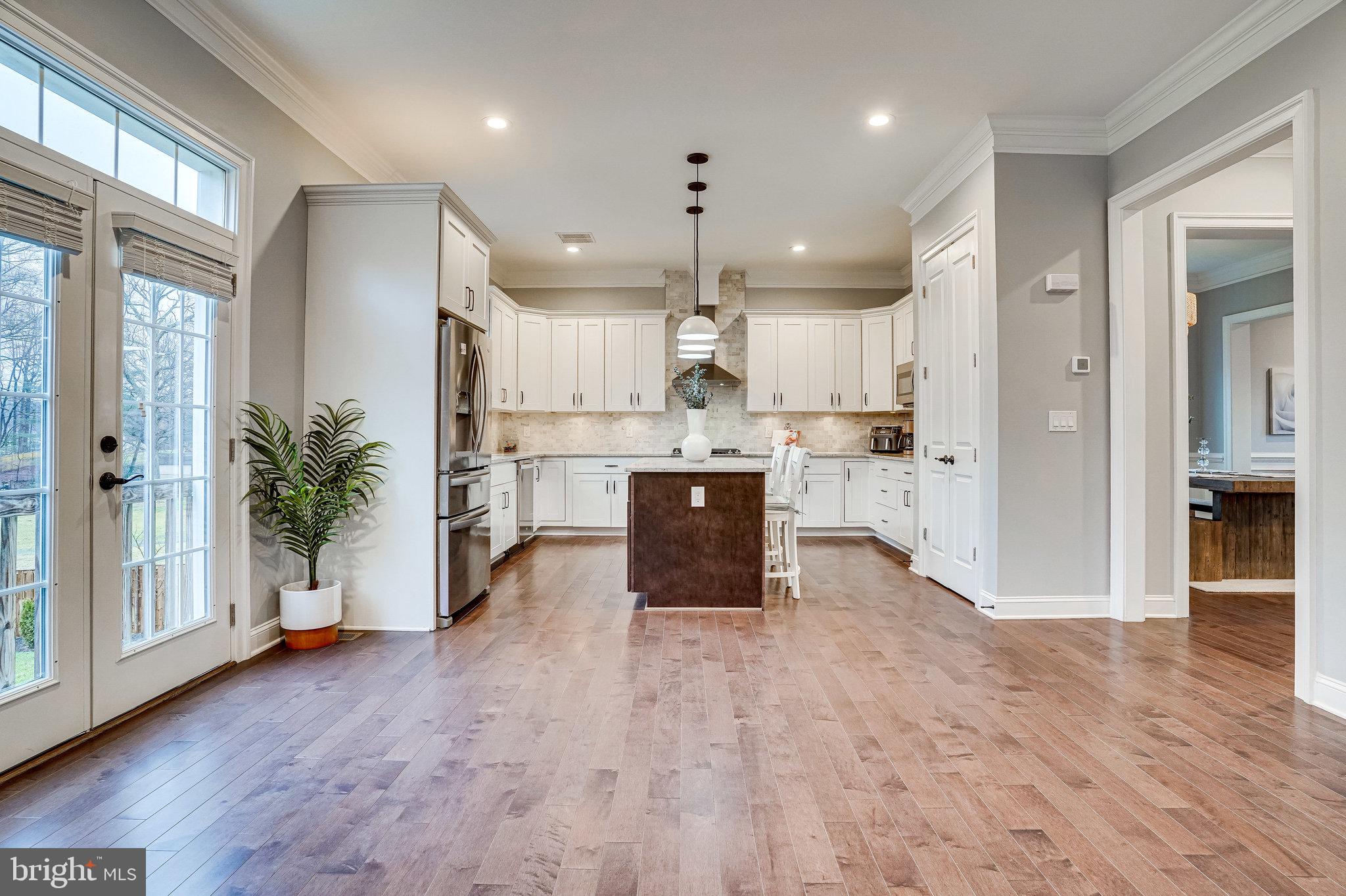 8733 Pohick Road Springfield, VA 22153 - Photo 10 of 40 a kitchen with stainless steel appliances granite countertop a refrigerator a sink dishwasher and a oven with white cabinets