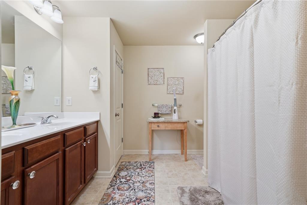608 Myers Gate Road Ball Ground, GA 30107 - Photo 19 of 31 a spacious bathroom with a sink and a mirror