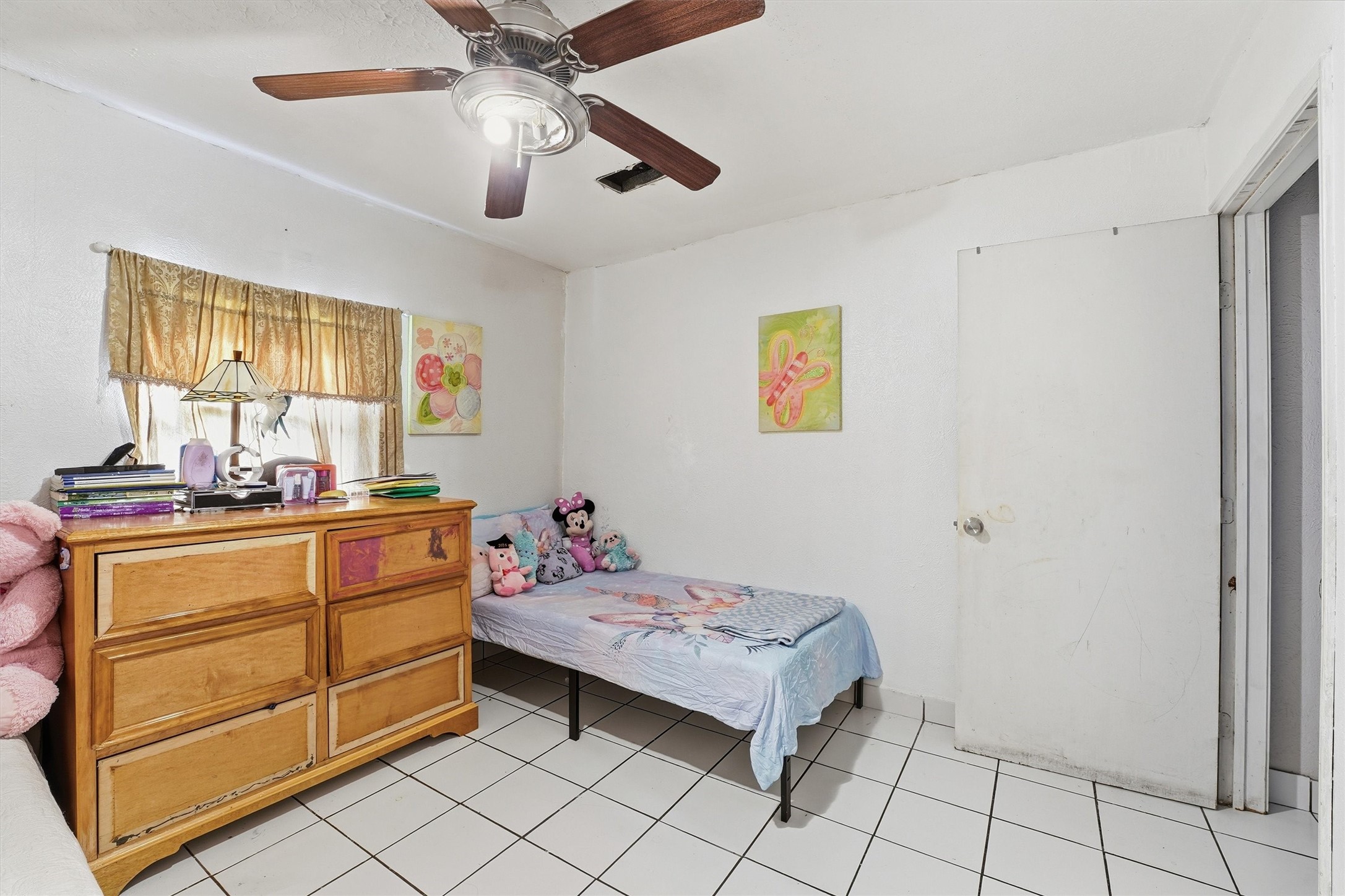 1002 Grenfell Lane Houston, TX 77076 - Photo 14 of 26 a bedroom with a bed and wooden floor