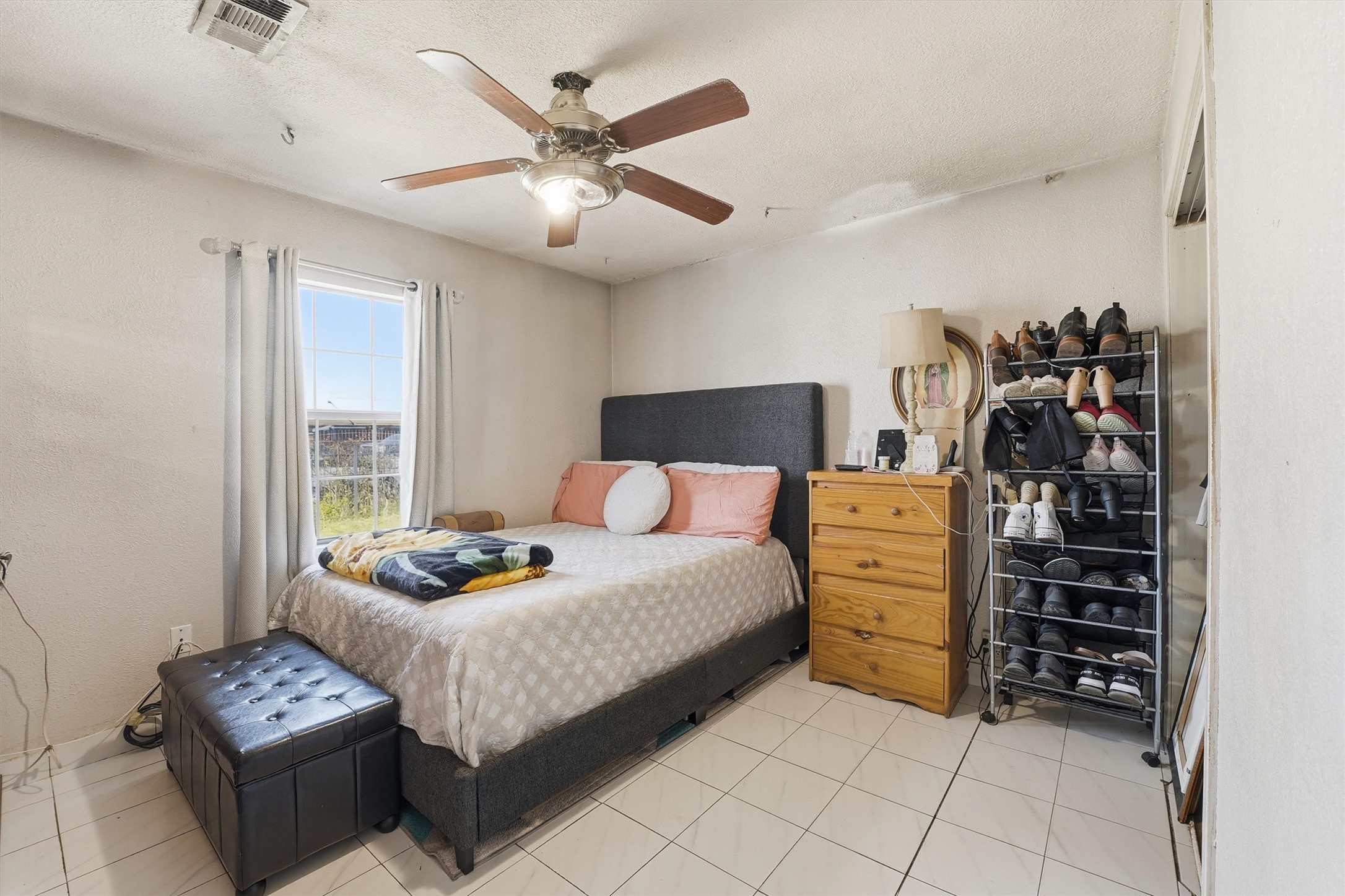 1002 Grenfell Lane Houston, TX 77076 - Photo 15 of 26 a bedroom with a bed and a chandelier