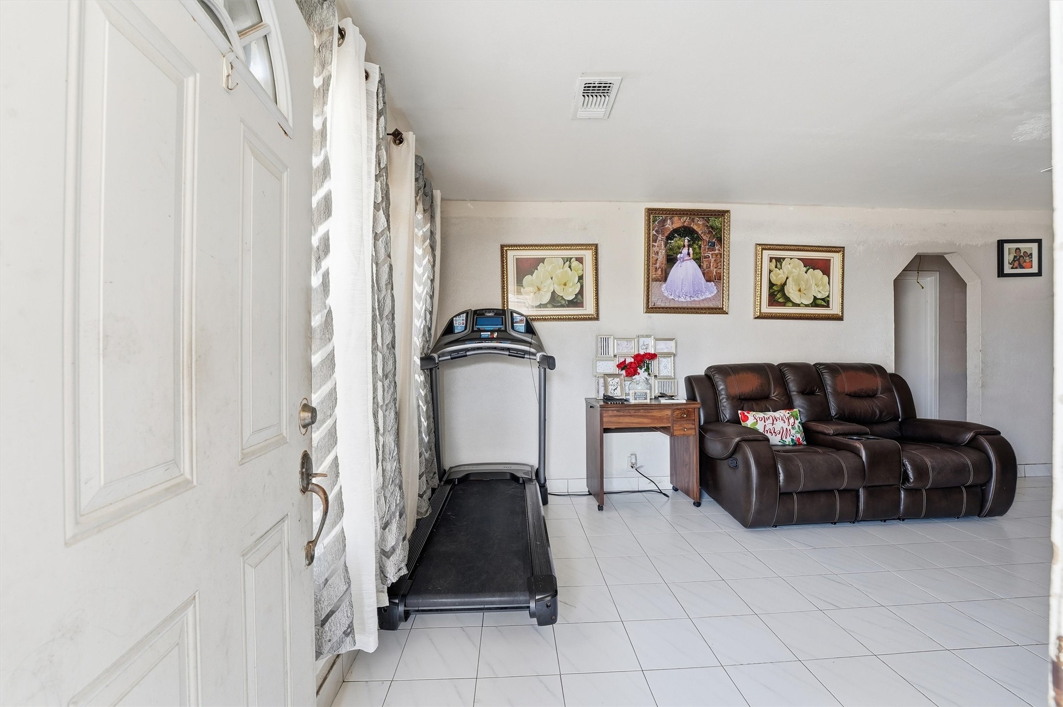 1002 Grenfell Lane Houston, TX 77076 - Photo 3 of 26 a living room with furniture and a refrigerator