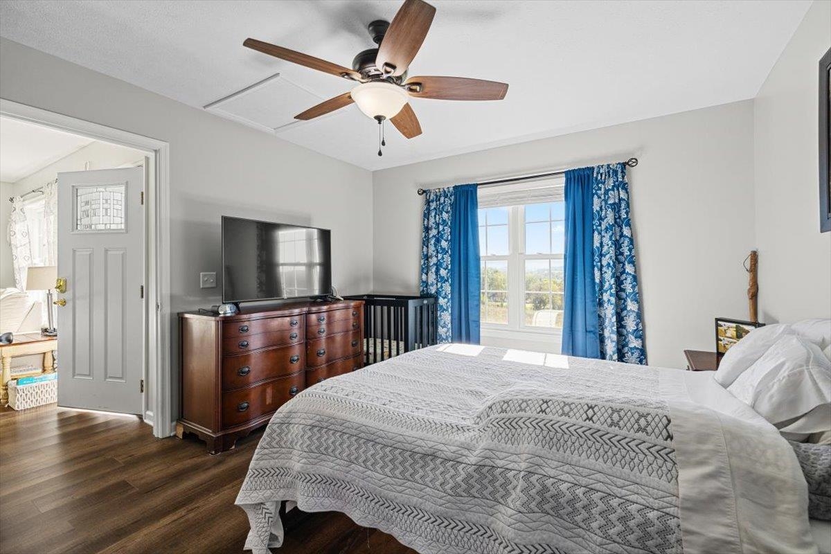 15531 Evergreen Valley Road Timberville, VA 22853 - Photo 15 of 34 a bedroom with a bed and a large mirror with wooden floor