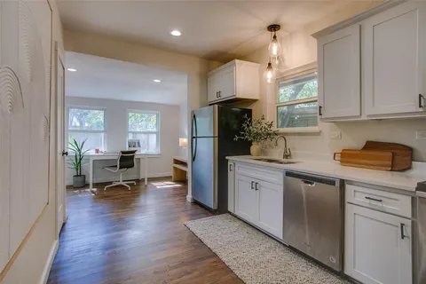a kitchen with refrigerator and window