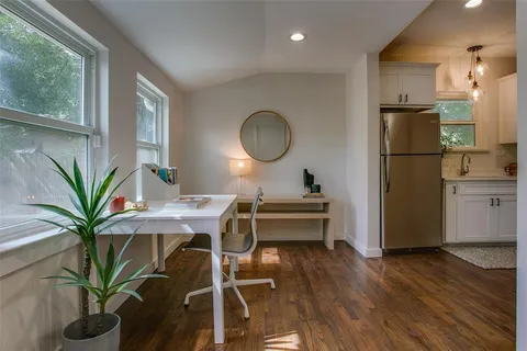 a view of a kitchen with a table and a chair
