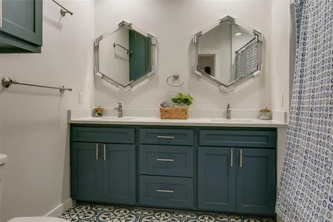 a bathroom with a sink vanity and mirror