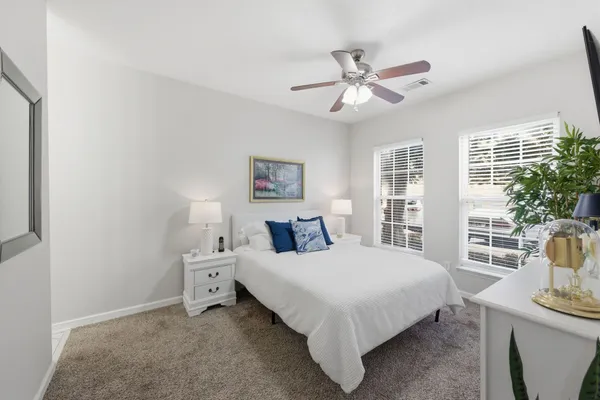 a bedroom with a bed and a chandelier