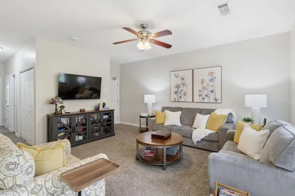 a living room with furniture and a flat screen tv