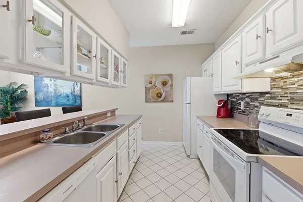 a kitchen that has a sink and a stove