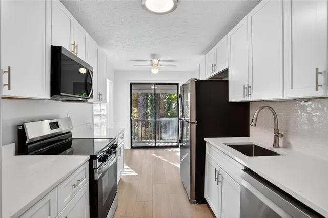a kitchen with a sink a stove and refrigerator