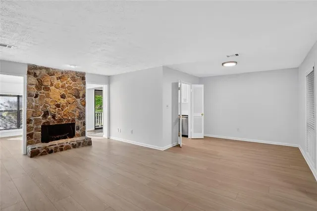 wooden floor in living room with a window