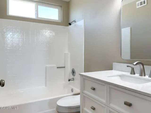 an empty room with closet and a window