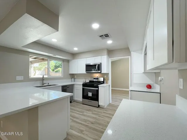 a kitchen with a sink stove and cabinets