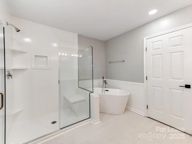 a spacious bathroom with a bathtub and a shower