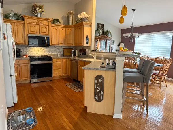a kitchen with stainless steel appliances granite countertop a stove and a sink