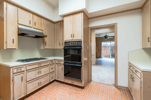 a kitchen with stainless steel appliances granite countertop a stove and a refrigerator