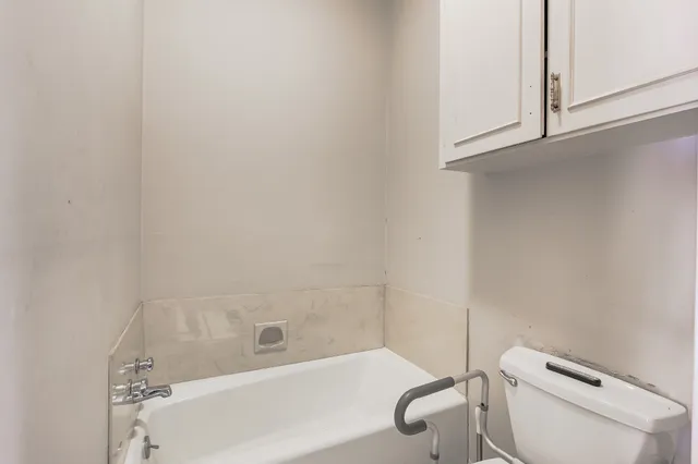 a bathroom with a toilet and a bathtub