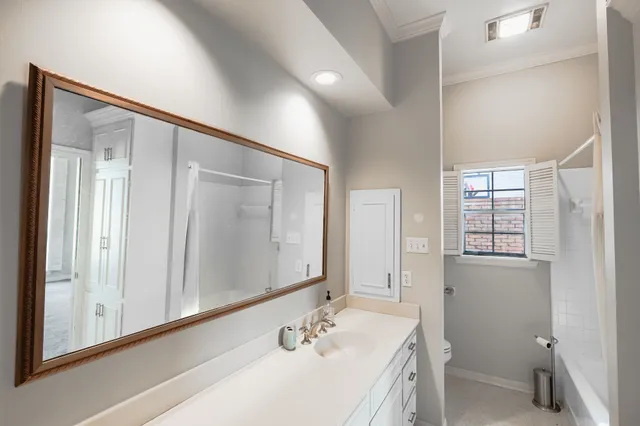 a bathroom with a granite countertop sink a mirror and a shower