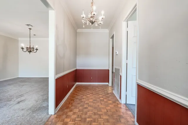 a view of a hallway with a chandelier