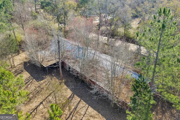 a view of a yard with wooden fence