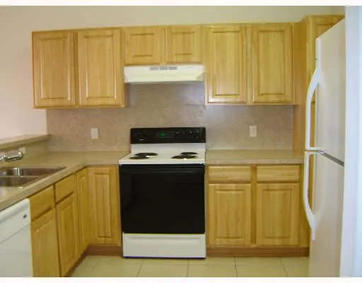 a kitchen with stainless steel appliances white cabinets and a sink