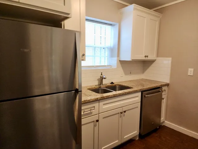 a kitchen with a sink and a refrigerator