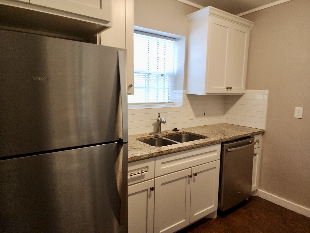 1409 Kirkwood Road, Unit A Austin, TX 78722 - Photo 3 of 15 a kitchen with a sink and a refrigerator