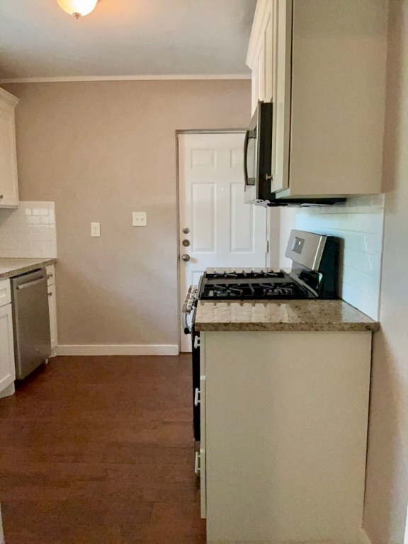1409 Kirkwood Road, Unit A Austin, TX 78722 - Photo 4 of 15 a kitchen with granite countertop cabinets stainless steel appliances and a counter space