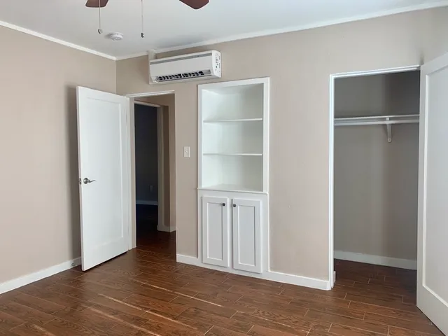 a view of an empty room with wooden floor