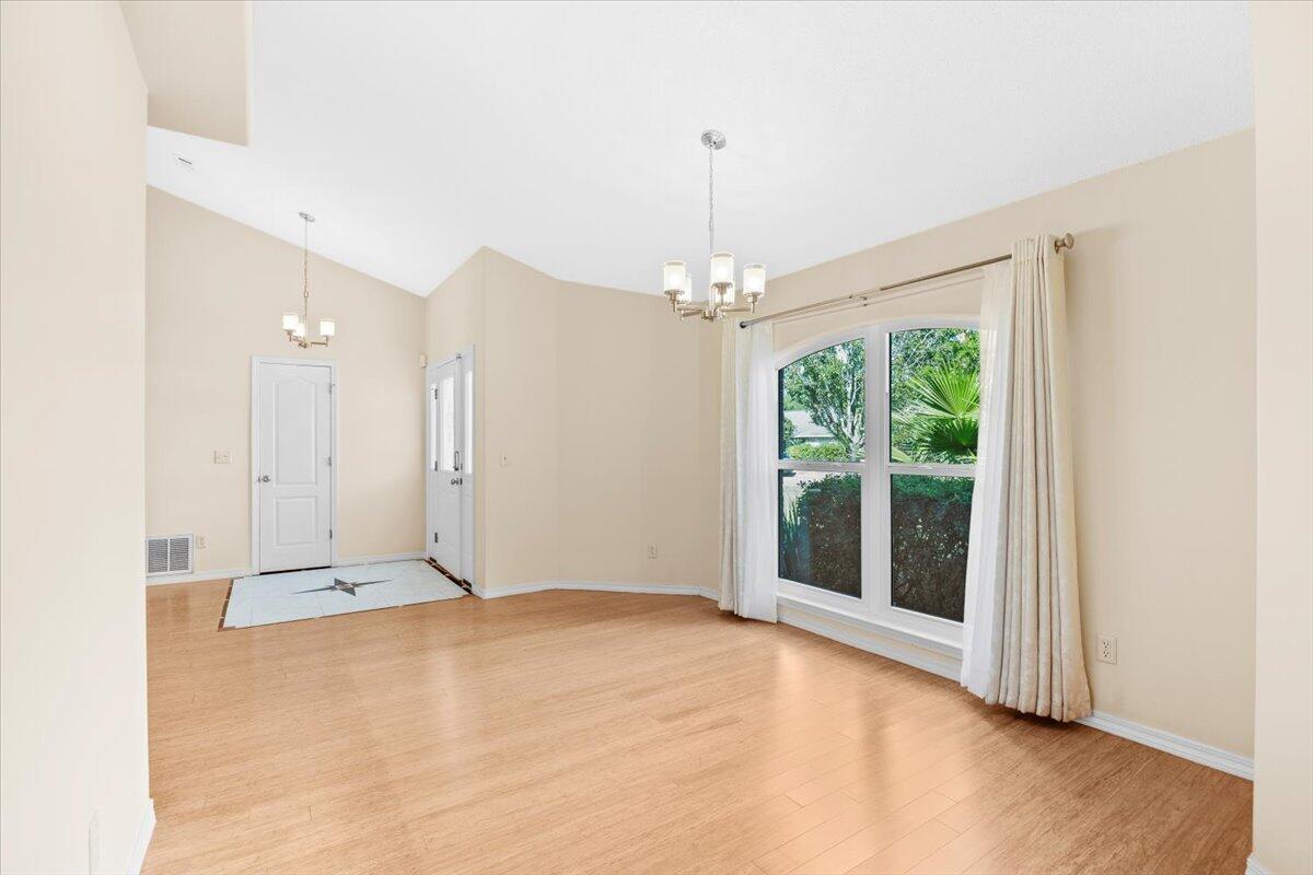 7807 Lola Circle Navarre, FL 32566 - Photo 11 of 45 a view of an empty room with window chandelier fan