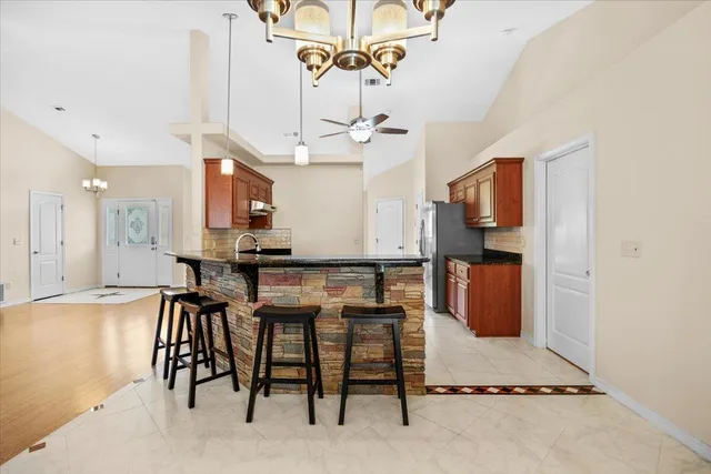 a view of a kitchen area kitchen island furniture and a ceiling fan