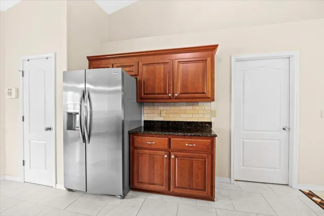 a bathroom with a granite countertop sink a toilet and a mirror