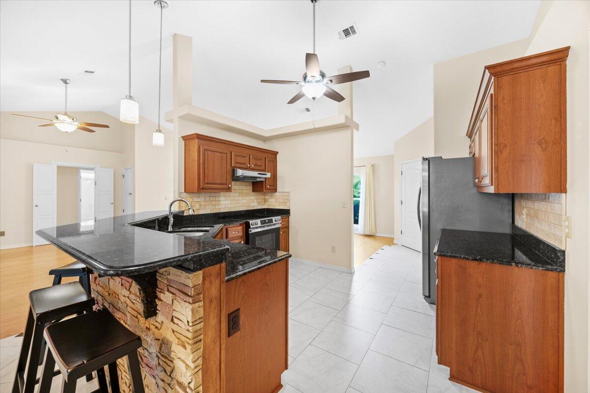7807 Lola Circle Navarre, FL 32566 - Photo 19 of 45 a view of a kitchen area kitchen island furniture and a ceiling fan