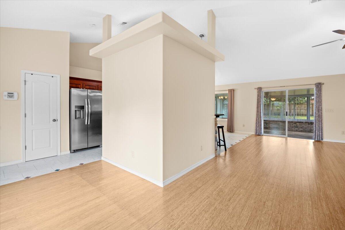 7807 Lola Circle Navarre, FL 32566 - Photo 20 of 45 a view of empty room with wooden floor and fireplace