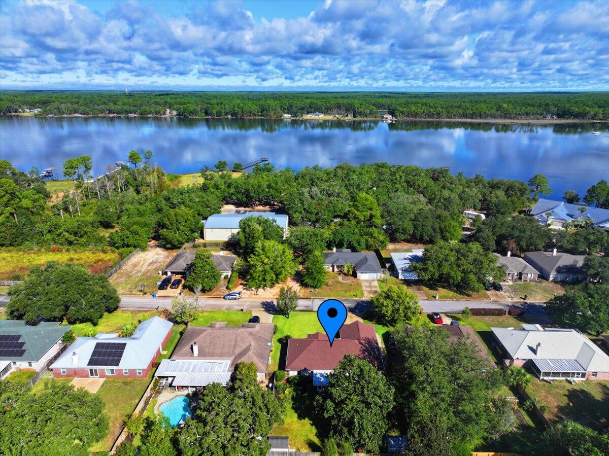7807 Lola Circle Navarre, FL 32566 - Photo 2 of 45 an aerial view of a house with a lake view
