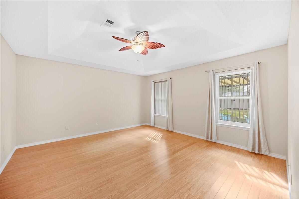 7807 Lola Circle Navarre, FL 32566 - Photo 22 of 45 an empty room with windows and fan