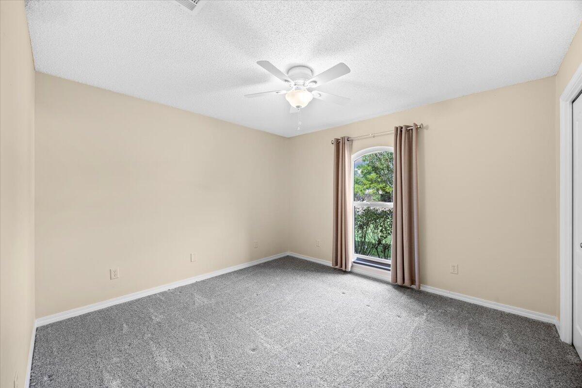 7807 Lola Circle Navarre, FL 32566 - Photo 27 of 45 an empty room with windows and fan