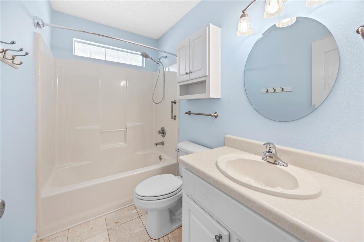 7807 Lola Circle Navarre, FL 32566 - Photo 28 of 45 a bathroom with a sink a toilet and a mirror
