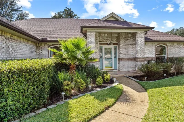 a front view of a house with garden