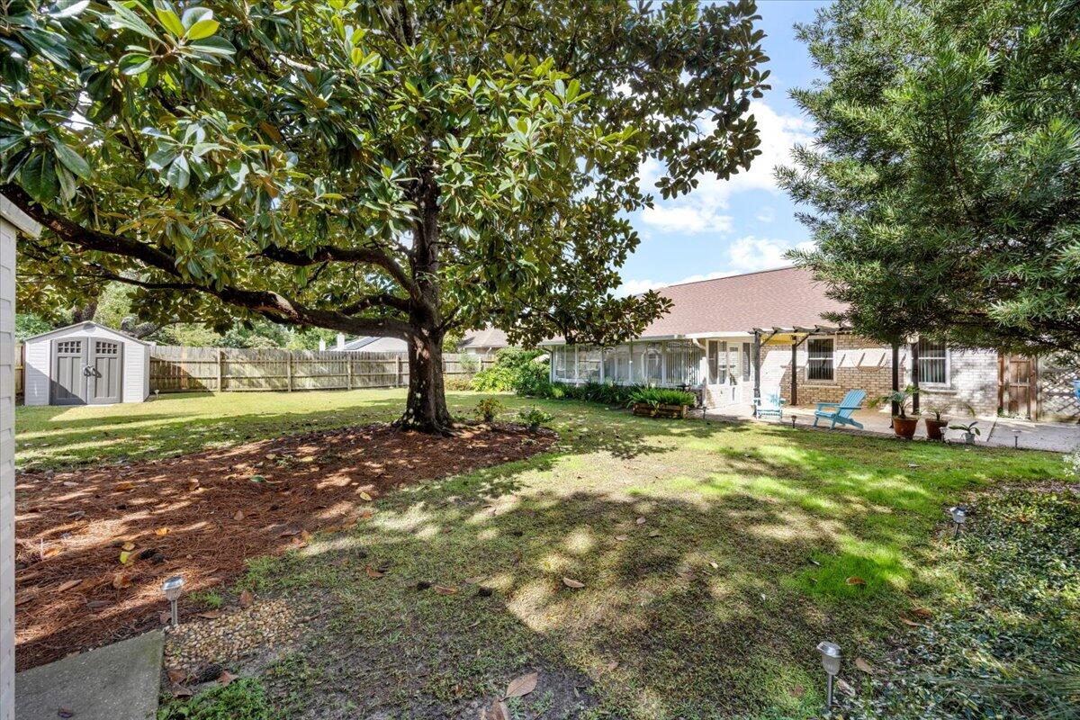 7807 Lola Circle Navarre, FL 32566 - Photo 34 of 45 a view of a house with a yard