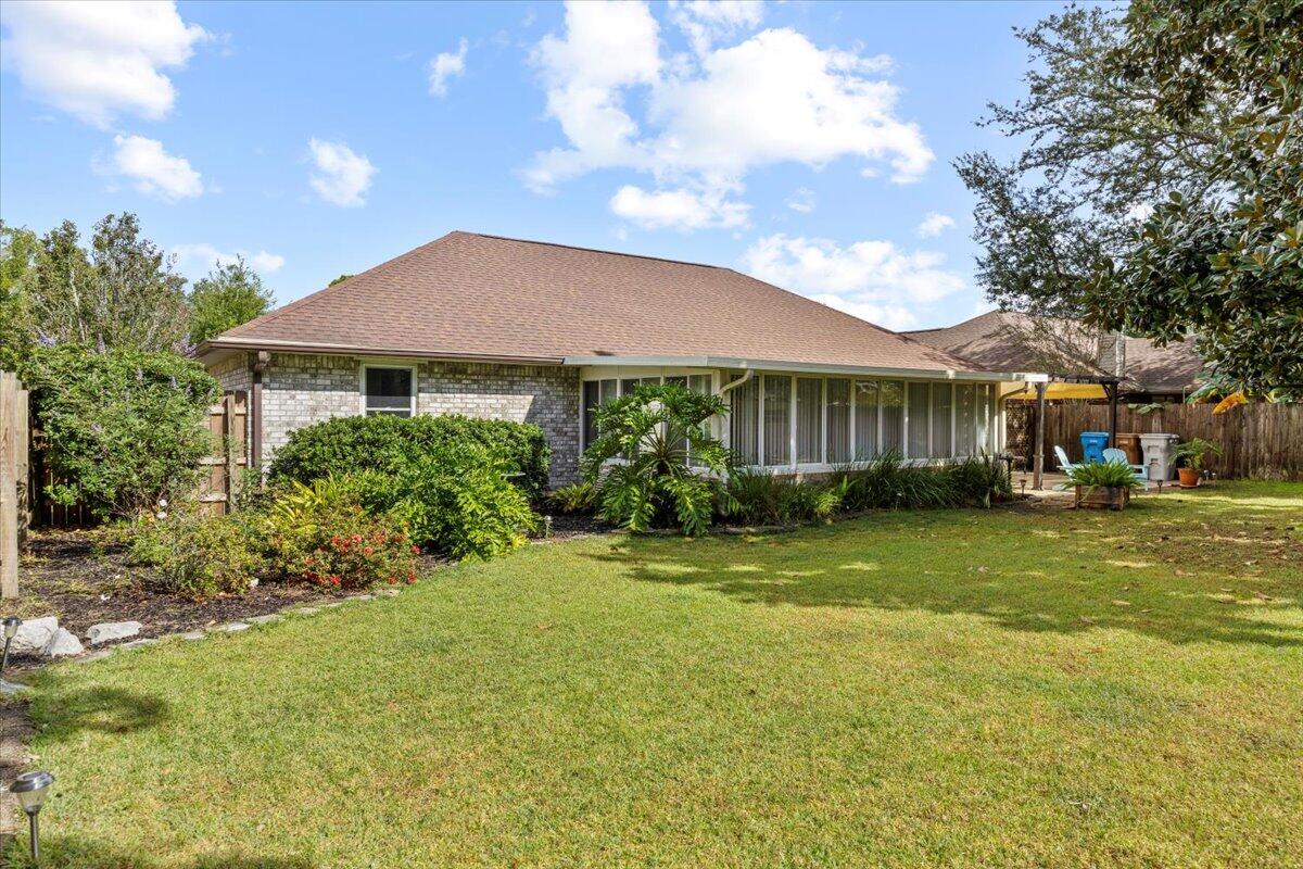 7807 Lola Circle Navarre, FL 32566 - Photo 35 of 45 a front view of a house with a garden