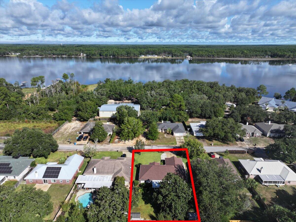 7807 Lola Circle Navarre, FL 32566 - Photo 40 of 45 an aerial view of a house with a lake view