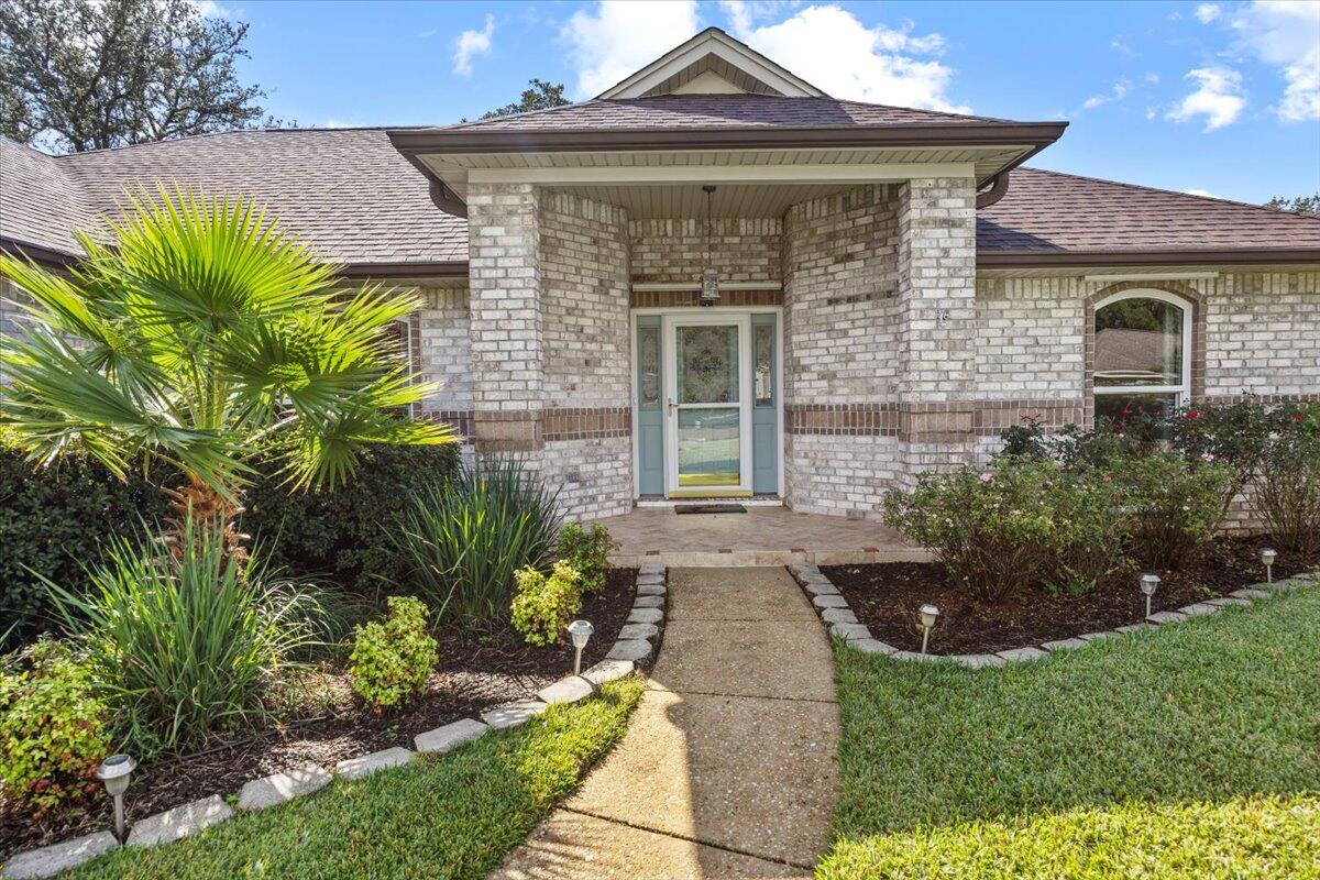 7807 Lola Circle Navarre, FL 32566 - Photo 4 of 45 a front view of a house with garden