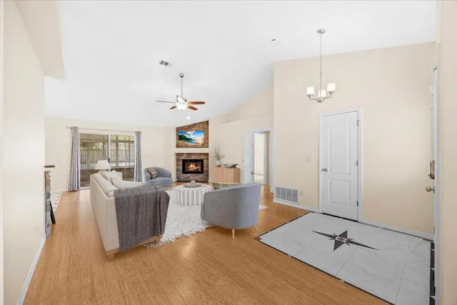 a view of an empty room with fire place and a fireplace